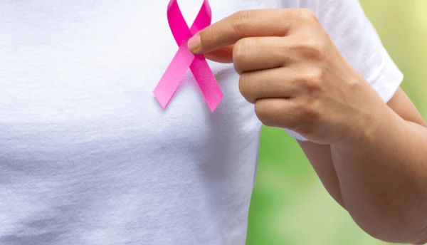 a women holding pink ribbon 🎗