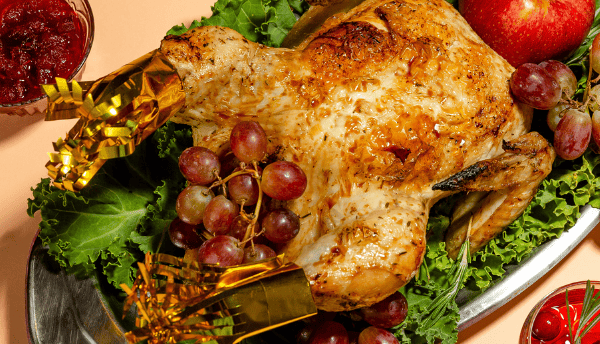 rosted turkey with fresh fruits and vegetabes on the table