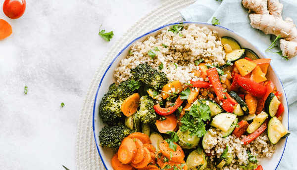 a vegetable bowl on table with fork