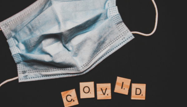 a mask and written covid with cross word