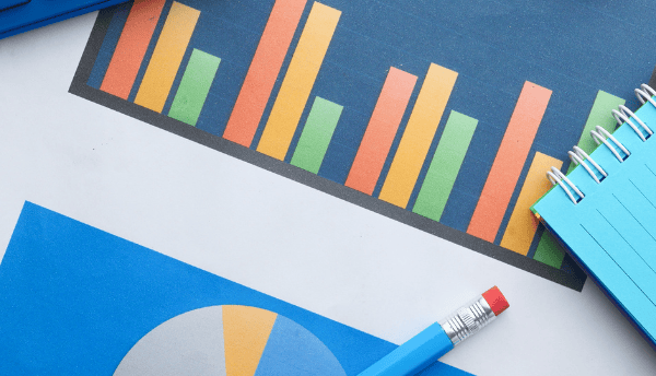 a pencil a calculator a notebook and a chart on the table