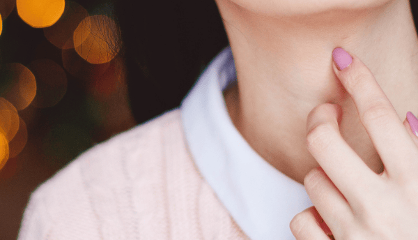 girls hand on her neck