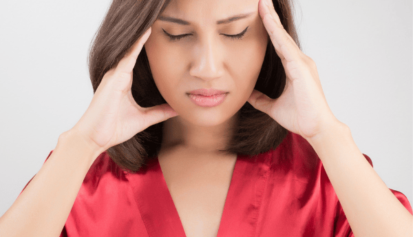a women  holding her head 