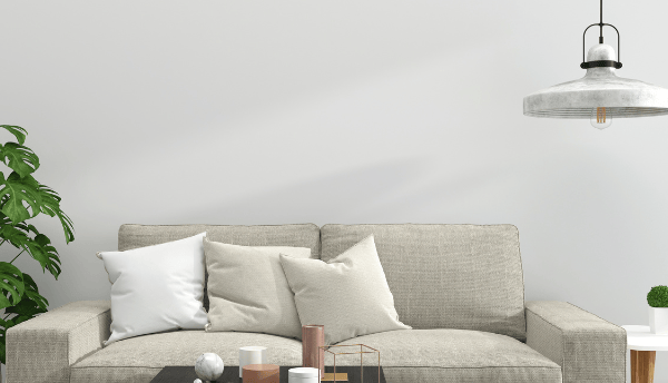 a room with Creem color sofa and table and lamp