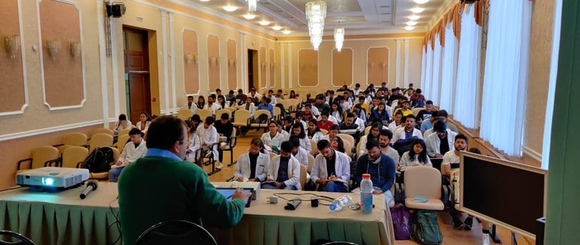 a large room with a lot of people sitting at tables
