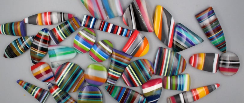 Surfite cabochobs made from upcycled surfboards in bright colours and shapes