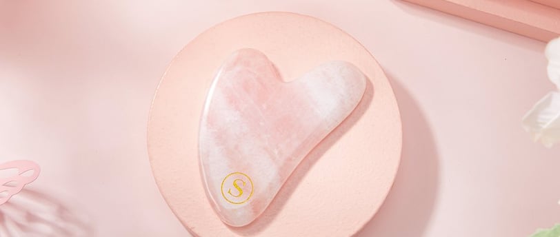 a pink heart shaped guasha on a pink plate