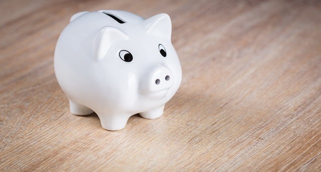 white piggy bank on a wooden desk