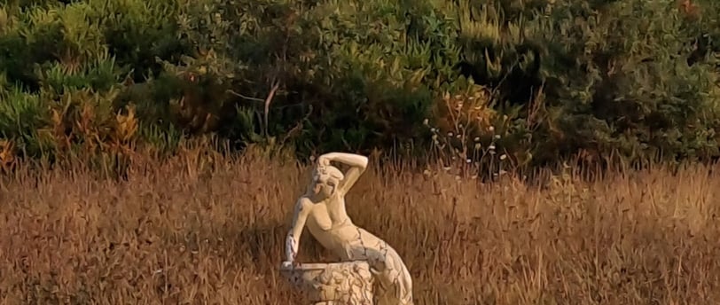 a statue of a man sitting on a rock