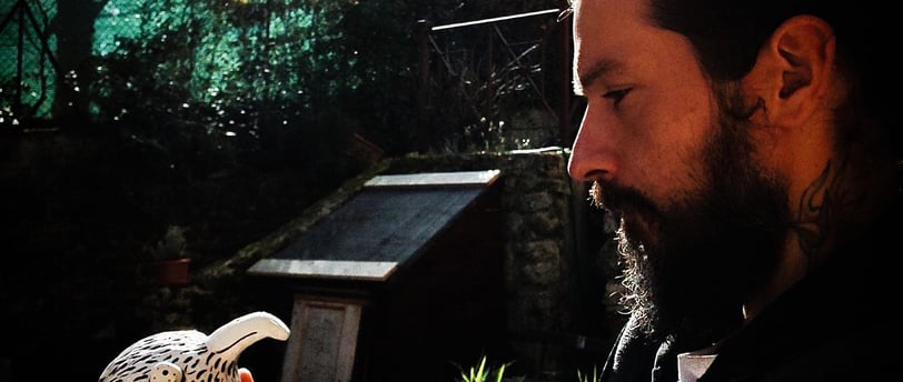 a man with a beard and a bird on his hand