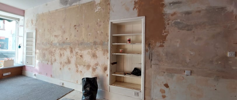 a wall during renovations with holes filled before papering