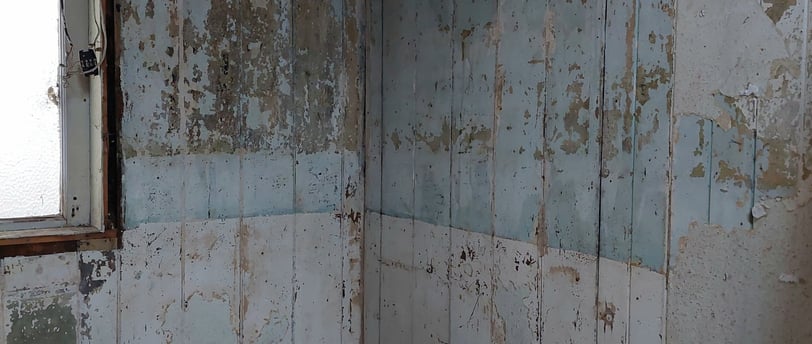 distressed wooden panelling with flaking paintwork