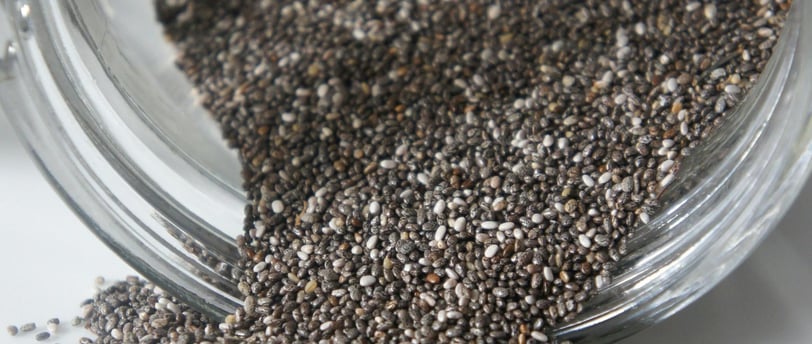 Chia seeds in a glass jar with a spoon, showcasing their potential to support healthy weight loss.