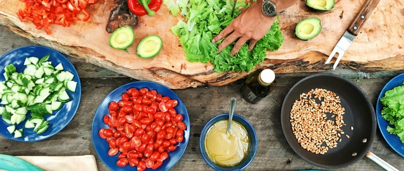A person enjoying a healthy meal with fruits, vegetables, and whole grains