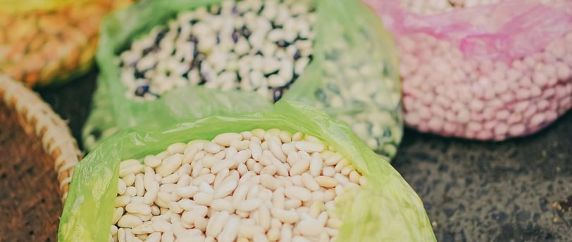 A variety of legumes, including lentils, chickpeas, and black beans, displayed in bowls