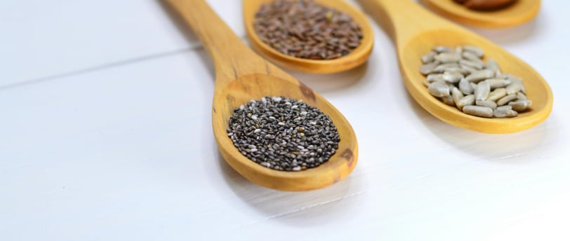 A variety of seeds including chia, flax, pumpkin, sunflower, and sesame seeds