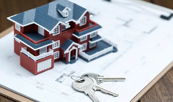 a house with keys and keys in front of a clipboard