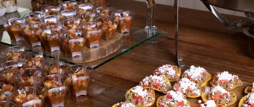 a table with a lot of food and drinks