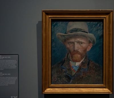 van gogh - a painting of a man with a hat on a wall