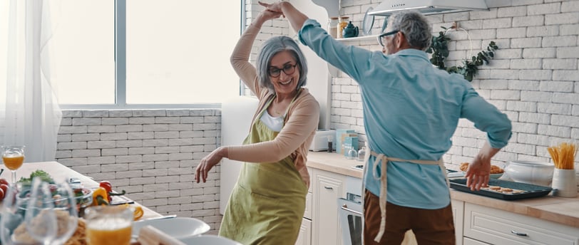 a man and woman dancing in a kitchen