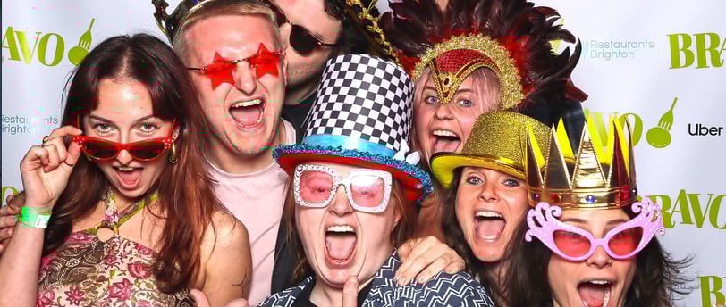 Group of young people pose for a photo in the Get The Picture booth at awards party event