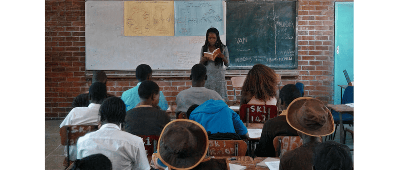 a classroom with a teacher and students in a classroom