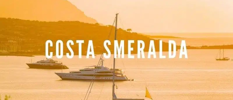 Luxury yacht illuminated by the golden light of sunset on the emerald sea of Sardinia’s northeastern