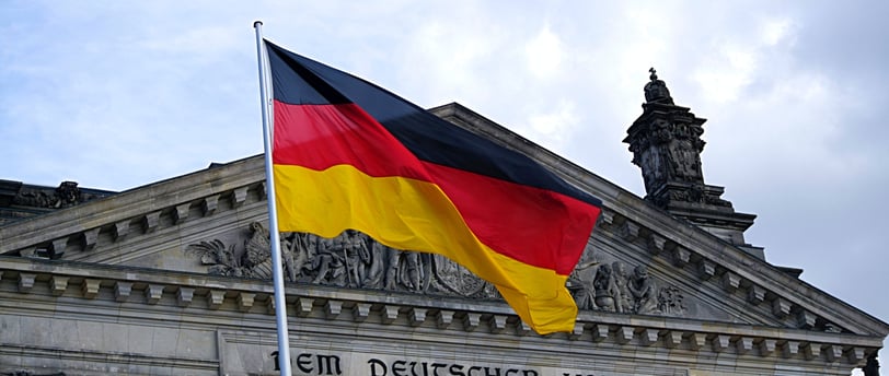 a large flag flying in front of a building