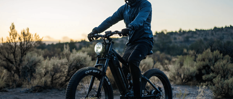 a man riding a Vitilan bike in the desert