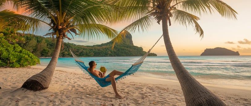 a woman sitting in a hammock on a beach