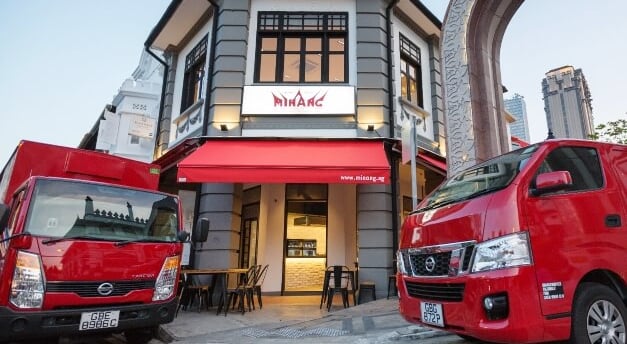 two red trucks parked in front of a building