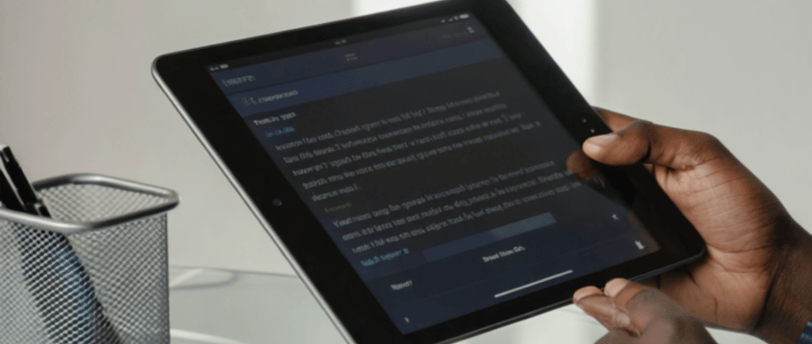 “Ipad screen showing a glowing PDF icon labeled ‘150 AI Prompts’ while creative ideas (light-bulb 