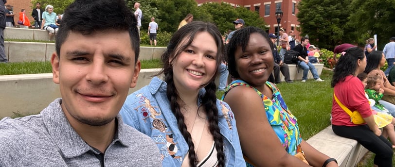 a Mexican man and a black and mixed women sitting and smiling 