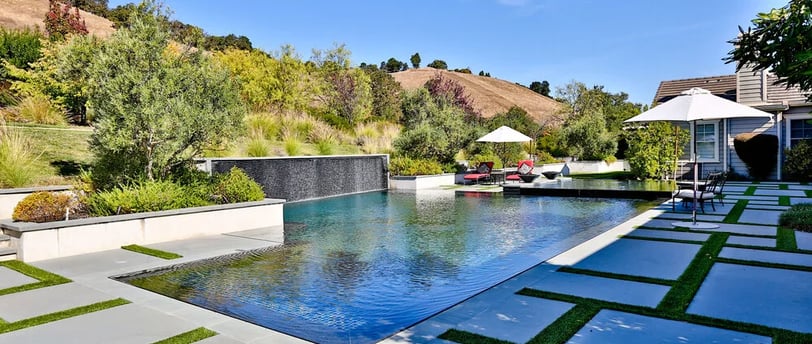 Aerial view of a custom luxury pool with lighting and spa in a Palo Alto backyard