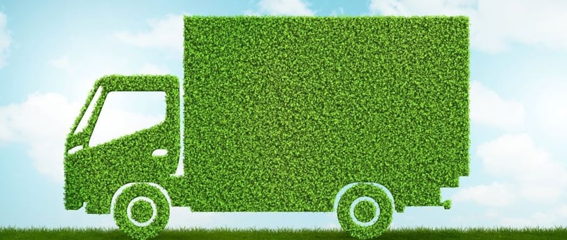 a truck covered in green grass