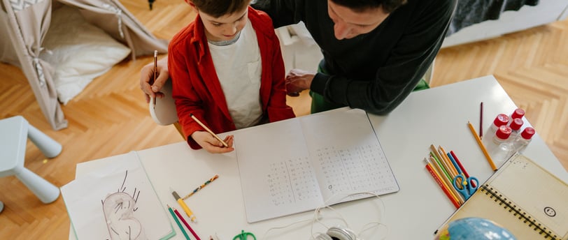 father and son working together on homeschool project