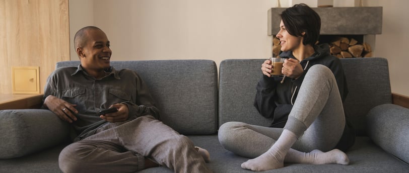 Couple talking on the couch. Photo by Katrin Bolovtsova on Pexels.