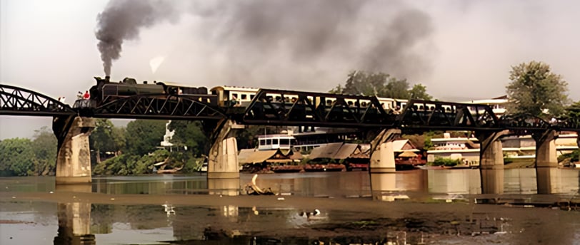 Stream Train crossing the Bridge on the river Kwai in Kanchanaburi , 2024 Toursofwar.com