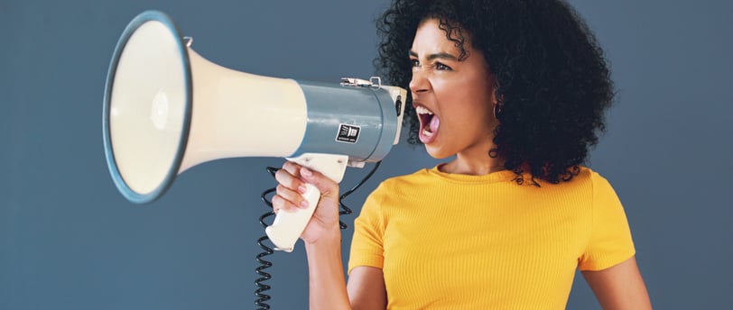 a woman with a yellow shirt and a megaphone