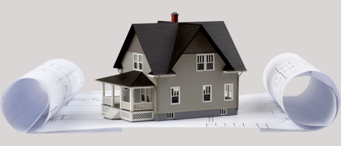 imagem de uma casa em miniatura em cima de um projeto em papel