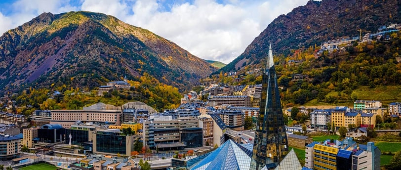 a view of a mountain range with a church steeple