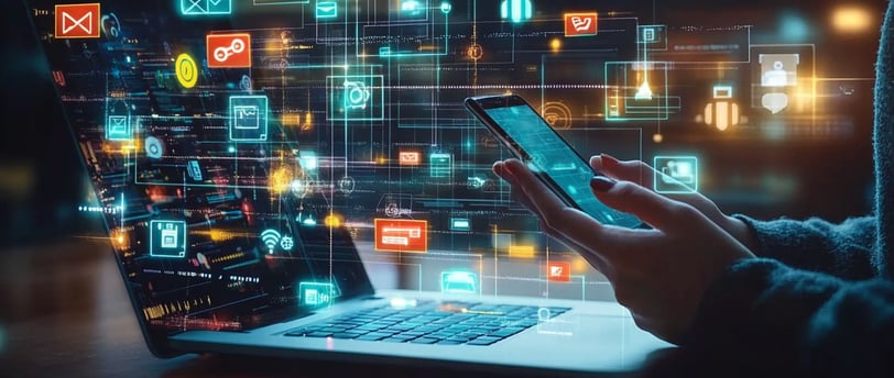a person holding a cell phone and a laptop