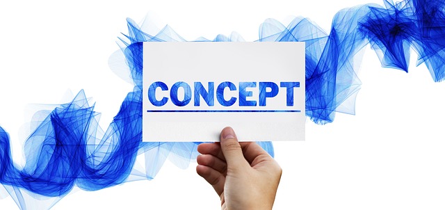 a person holding a piece of paper with the word concept
