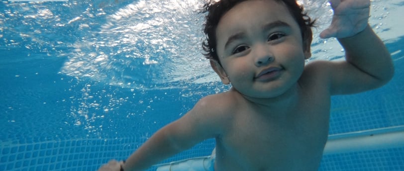 a young child swimming in a pool