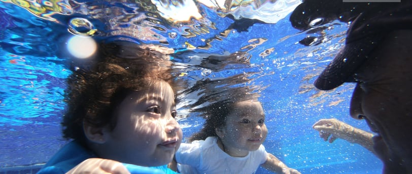 a woman and a man are swimming in the water