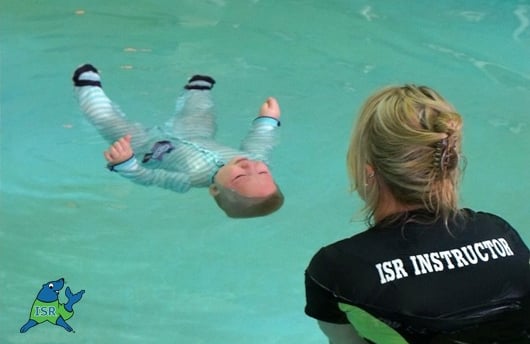 a woman in a wetsuit is swimming in a pool