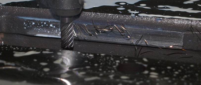 a machine that is cutting into a piece of metal