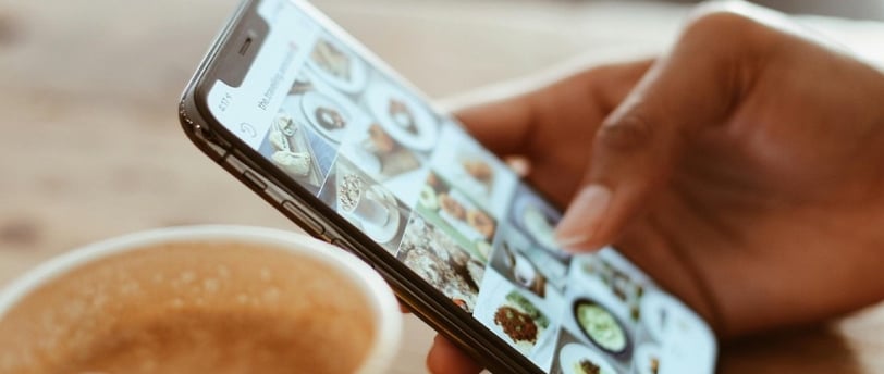 Celular na mão de uma pessoa vendo como recuperar fotos do Orkut