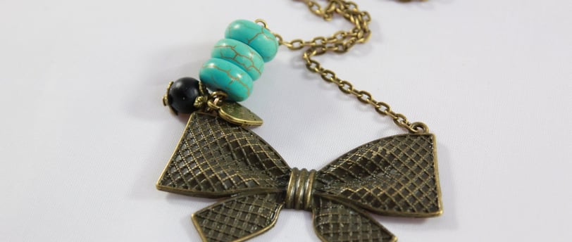 a necklace with a bow tie and a necklace with a bow