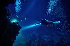 a diver in a cave in the ocean north bali